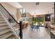 Bright open living area with soaring ceilings, a staircase, and an adjacent modern eat in kitchen at 4611 Grand Preserve Pl, Palm Harbor, FL 34684