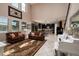 Spacious living room features tall ceilings and an open layout connected to an updated kitchen with dark wood cabinets at 4611 Grand Preserve Pl, Palm Harbor, FL 34684