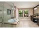 Bright main bathroom with glass shower, garden tub, and dual vanity for a relaxing spa-like experience at 4611 Grand Preserve Pl, Palm Harbor, FL 34684