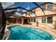 A beautiful screened pool and deck area offers a delightful and private backyard space at 4611 Grand Preserve Pl, Palm Harbor, FL 34684