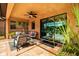 Relaxing screened patio features outdoor seating and views of the beautifully landscaped backyard at 4611 Grand Preserve Pl, Palm Harbor, FL 34684