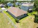 Aerial view of a well-maintained home with a fenced backyard in a residential neighborhood at 4690 Coachford Dr, Wesley Chapel, FL 33543