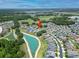 Aerial view of a lakeside community featuring homes with mature landscaping and a water view at 4690 Coachford Dr, Wesley Chapel, FL 33543