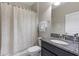 Bathroom featuring granite countertop, single sink, shower with patterned curtain and towel rack at 4690 Coachford Dr, Wesley Chapel, FL 33543