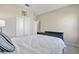 Bedroom featuring a bed with white comforter, complemented by closet and dresser at 4690 Coachford Dr, Wesley Chapel, FL 33543