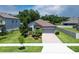 Charming one-story home with a brick driveway, stone accents and a well maintained front yard at 4690 Coachford Dr, Wesley Chapel, FL 33543