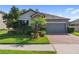 Charming single-Gathering home with well-manicured lawn, brick driveway and 2-car garage at 4690 Coachford Dr, Wesley Chapel, FL 33543