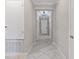 Hallway with neutral walls and tiled floor at 4690 Coachford Dr, Wesley Chapel, FL 33543