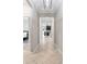 Hallway with tiled floor leading to bedroom and kitchen at 4690 Coachford Dr, Wesley Chapel, FL 33543