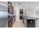 Kitchen with stainless steel appliances, dark cabinets, granite countertops, and tiled floor at 4690 Coachford Dr, Wesley Chapel, FL 33543