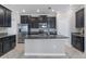 Modern kitchen featuring stainless steel appliances, granite countertops, and a center island at 4690 Coachford Dr, Wesley Chapel, FL 33543