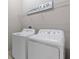 Laundry room with washer, dryer, wire shelf, and 'Laundry Co.' sign above at 4690 Coachford Dr, Wesley Chapel, FL 33543