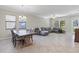 Spacious living area with tile flooring, large windows, and comfortable seating arrangement at 4690 Coachford Dr, Wesley Chapel, FL 33543
