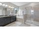Elegant main bathroom features a double vanity, soaking tub, and glass-enclosed shower at 4690 Coachford Dr, Wesley Chapel, FL 33543
