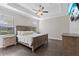 Serene main bedroom with tray ceilings, wood floors, and natural light, enhancing relaxation at 4690 Coachford Dr, Wesley Chapel, FL 33543