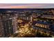 Nighttime aerial view shows city lights, the harbor, and nearby buildings under a colorful sunset sky at 470 3Rd S St # 602, St Petersburg, FL 33701