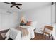 Inviting bedroom featuring dark wood floors, a ceiling fan, double closet, and lots of light at 470 3Rd S St # 602, St Petersburg, FL 33701