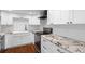 Well-lit kitchen with white cabinetry, granite countertops, stainless appliances, and hardwood floors at 470 3Rd S St # 602, St Petersburg, FL 33701