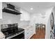 Updated kitchen with white cabinets, modern appliances, and hardwood floors at 470 3Rd S St # 602, St Petersburg, FL 33701