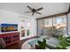 Inviting living room featuring balcony access, a ceiling fan, and a stylish rug for added comfort at 470 3Rd S St # 602, St Petersburg, FL 33701