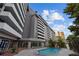 Beautiful pool area, surrounded by trees, lounge chairs and a modern building at 470 3Rd S St # 602, St Petersburg, FL 33701