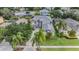 Aerial view of home with lush landscaping, fenced yard, and community pool at 4915 Augusta Ave, Oldsmar, FL 34677
