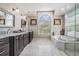 Luxury bathroom featuring double vanity, soaking tub, and frameless glass shower at 4915 Augusta Ave, Oldsmar, FL 34677