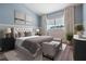 A beautifully staged bedroom includes new furnishings, natural lighting, and an ensuite bathroom at 4915 Augusta Ave, Oldsmar, FL 34677