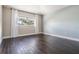 Bright bedroom featuring hardwood floors, a large window, and neutral wall colors at 4915 Augusta Ave, Oldsmar, FL 34677
