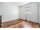 Bedroom featuring hardwood floors, a large window, and neutral wall colors at 4915 Augusta Ave, Oldsmar, FL 34677