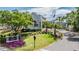 Community clubhouse with well-manicured landscaping, signage, and an American flag at 4915 Augusta Ave, Oldsmar, FL 34677