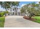 Two-story home featuring a stucco exterior, three-car garage, with mature trees in the front yard at 4915 Augusta Ave, Oldsmar, FL 34677