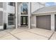 Close-up of the front exterior featuring a grand entrance with a black door and an attached garage at 4915 Augusta Ave, Oldsmar, FL 34677