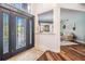 Elegant foyer featuring a decorative glass door, hardwood floors, and an open view into the living room at 4915 Augusta Ave, Oldsmar, FL 34677