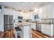 Modern kitchen with white cabinets, stainless steel appliances, and a center island with seating at 4915 Augusta Ave, Oldsmar, FL 34677