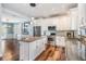 Bright kitchen features an island, stainless steel appliances, and stylish pendant lighting at 4915 Augusta Ave, Oldsmar, FL 34677