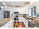 Bright kitchen with white cabinets, stainless steel appliances and granite countertops at 4915 Augusta Ave, Oldsmar, FL 34677