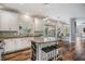 Bright kitchen showcases white cabinetry, granite countertops, stainless steel appliances, and an island with seating at 4915 Augusta Ave, Oldsmar, FL 34677