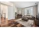 Bright living room with neutral colors, hardwood floors, large window, and comfortable furniture at 4915 Augusta Ave, Oldsmar, FL 34677