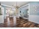 Spacious open-concept living space featuring hardwood floors, a view to the kitchen, and ample natural light at 4915 Augusta Ave, Oldsmar, FL 34677