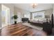 A spacious main bedroom features beautiful hard wood floors, natural lighting, and an ensuite bathroom at 4915 Augusta Ave, Oldsmar, FL 34677