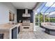 Outdoor kitchen with built-in grill, stone countertops, and convenient bar area at 4915 Augusta Ave, Oldsmar, FL 34677