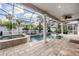 Beautiful pool area with spa, screened enclosure, and lush tropical landscaping at 4915 Augusta Ave, Oldsmar, FL 34677