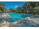 Outdoor swimming pool with marked lanes, lounge chairs, and shaded pergola areas at 4915 Augusta Ave, Oldsmar, FL 34677