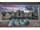Screened pool with palms and view of a colorful dusk sky, and a raised spa at 4915 Augusta Ave, Oldsmar, FL 34677