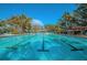 Large outdoor swimming pool featuring lane markers and nearby lounge chairs under shade structures at 4915 Augusta Ave, Oldsmar, FL 34677