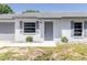 Close up view of a single-story home with a fresh exterior and trimmed landscaping at 5341 Tangerine Dr, Zephyrhills, FL 33542