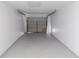 Bright garage with painted concrete walls and epoxy flooring at 5341 Tangerine Dr, Zephyrhills, FL 33542