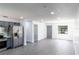 Open floor plan with a modern kitchen featuring stainless steel appliances and gray cabinets at 5341 Tangerine Dr, Zephyrhills, FL 33542