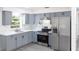 Updated kitchen featuring stainless steel appliances, modern cabinetry, quartz counters, and stylish backsplash at 5341 Tangerine Dr, Zephyrhills, FL 33542
